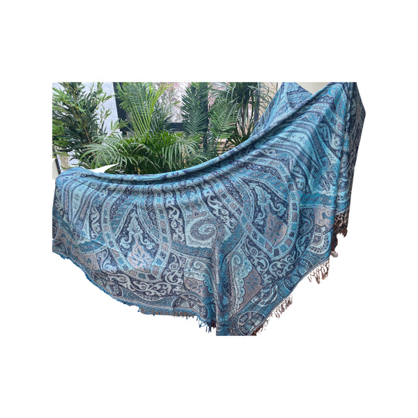 Reversible Cashmerebedspread or throw in black and turquoise, paisley - handwoven; used here to cover a cross trainer!